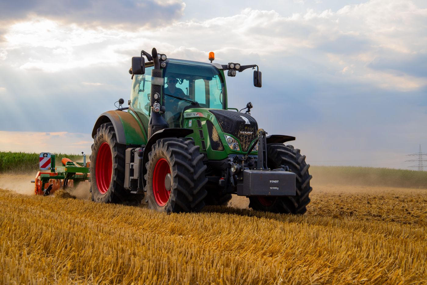 A tractor working a field at golden hour